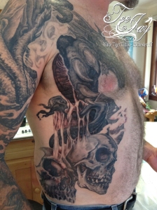 skulls on ribs tattoo